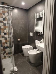 a bathroom with a toilet and a sink and a shower at Hotel Palace in Varazze