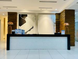 a lobby with a reception desk in a building at trendy & Reliable Condo unit in Davao City