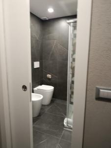 a bathroom with a toilet and a glass door at Hotel Palace in Varazze +67 photos