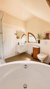 a white bathroom with a tub and a toilet at Pauline 3 in Templin +37 photos