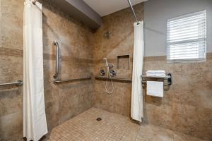 a bathroom with a shower with a shower curtain at Motel 6-Anaheim, CA - Convention Center in Anaheim +27 photos