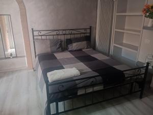 a bedroom with a bed with a black and blue checkered at Living Milano Suite in Cinisello Balsamo +4 photos