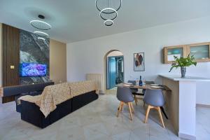 a living room with a couch and a table at Villa Escapes By The Beach in Sidari