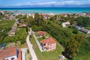 an aerial view of a house on a hill next to the ocean at Villa Escapes By The Beach in Sidari