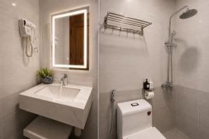a bathroom with a sink and a toilet and a mirror at Amelia House - Boutique Hotel in Khu Chi Lăng +82 photos