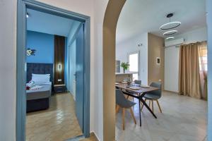 a room with a dining table and a bedroom at Villa Escapes By The Beach in Sidari