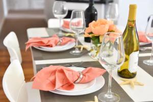 a table with plates and glasses and wine bottles at Downtown Suite #4 - Wharf View in Newport