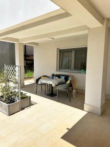 a patio with a table and chairs on a patio at Apartments Karmen Maria in Novigrad Istria