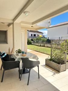 a patio with a table and chairs on a patio at Apartments Karmen Maria in Novigrad Istria
