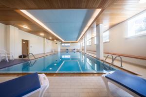 a large swimming pool in a building at Alpenblick-Apartment mit Pool & Sauna in St. Moritz