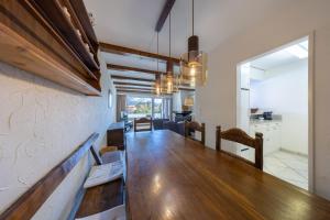 a dining room with a long wooden table in a room at Alpenblick-Apartment mit Pool & Sauna in St. Moritz