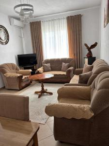 a living room with two couches and a table at Villa 7 in Durrës