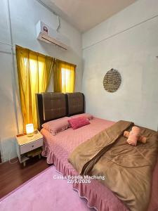 a bedroom with a bed with pink sheets and pink pillows at Cassa Bonda Standard Double Room in Macang