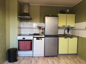 a kitchen with white appliances and yellow cabinets at Ruumikas looduslik pärl- Self check-in in Viljandi
