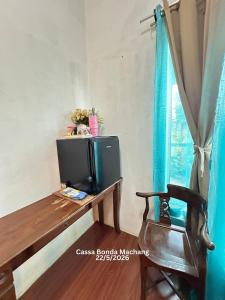 a television sitting on a table next to a window at Cassa Bonda Standard Double Room in Macang