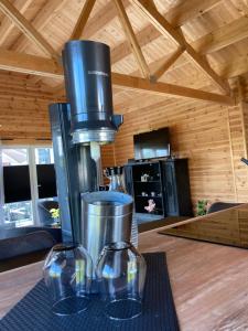two wine glasses sitting on a table with a juicer at Hagens Cottage in Wanfried