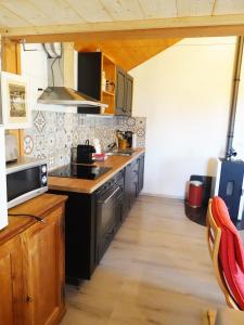 a kitchen with a sink and a stove at "Les Échalas" Charmante maison au coeur du Lavaux, Cully in Cully +10 photos