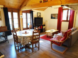 a living room with a table and a couch at "Les Échalas" Charmante maison au coeur du Lavaux, Cully in Cully