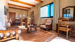 a living room filled with furniture and a table at Bio et Bois -Luxury Bio Farm- in Moulay Yacoub +116 photos