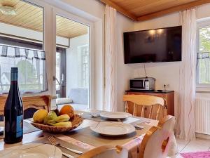 a dining room with a table with a bottle of wine at Apartment Sirch-2 by Interhome in Diedorf