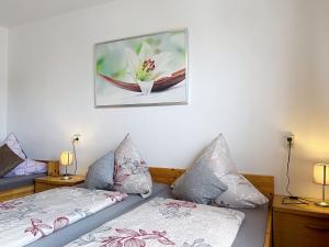 a bedroom with two beds and a picture on the wall at Apartment Sirch-2 by Interhome in Diedorf