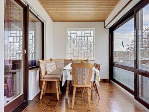 a dining room with a table and chairs and windows at Apartment Sirch-2 by Interhome in Diedorf +22 photos