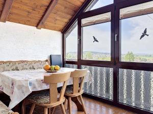 a dining room with a table and chairs and windows at Apartment Sirch-3 by Interhome in Diedorf