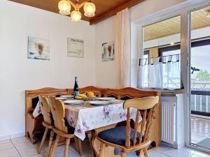 a dining room with a table and chairs at Apartment Sirch-4 by Interhome in Diedorf +25 photos