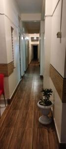 a hallway with a plant in the middle of a building at Hotel MeghTora in Goālpāra
