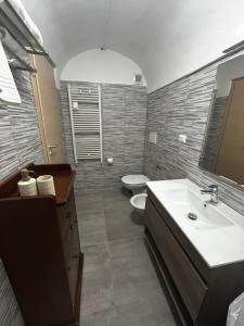 a bathroom with a sink and a toilet at Largo Otranto - Guest House in Brindisi +28 photos
