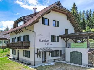 a large white house with a wooden roof at Apartment Apartment 5 by Interhome in Sirnitz