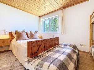 a bedroom with a bed and a window at Apartment Apartment 5 by Interhome in Sirnitz