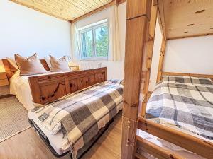 a bedroom with two beds and a window at Apartment Apartment 5 by Interhome in Sirnitz