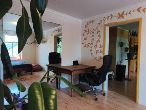 a dining room with a wooden table and chairs at Ruumikas looduslik pärl- Self check-in in Viljandi