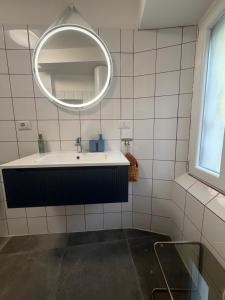 a bathroom with a tub and a mirror at Stresa Complex LevOasi in Stresa
