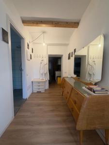a bathroom with a large mirror and a dresser at Stresa Complex LevOasi in Stresa