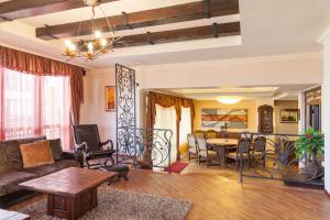 a living room with a couch and a table at Любомировата къща in Sredni Kolibi
