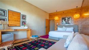 a bedroom with a bed and a couch at Bio et Bois -Luxury Bio Farm- in Moulay Yacoub