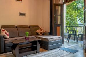 a living room with a couch and a table at Hill Top Villa Kandy in Ambatenna