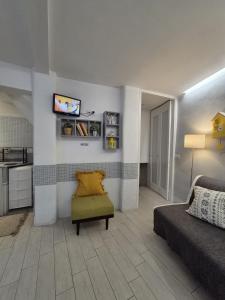 a living room with a couch and a tv on a wall at PapalePapale Home in Viterbo