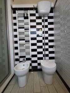 a bathroom with a toilet and a bidet at PapalePapale Home in Viterbo +12 photos