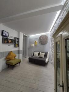 a living room with a couch and a chair at PapalePapale Home in Viterbo