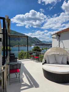 a balcony with a bed and a view of the water at Studio Scala in a seaside house in Dobrota +11 photos