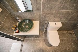 a bathroom with a toilet and a sink at Mộc in Ấp Ða Lợi +15 photos