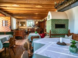 a restaurant with tables and chairs and wooden ceilings at Hotel Latemar in Soprabolzano
