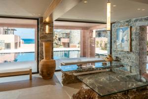 a living room with a glass table and a large window at Volta Seaside Boutique Hotel in Kokkini Khanion +150 photos