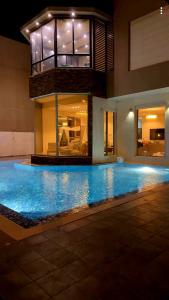 a swimming pool in a house with a building at Villa with private Pool A in Al Khīrān +20 photos