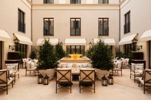 a courtyard with a fountain in the middle of a building at Corinthia Rome in Rome