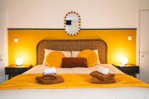 a bedroom with a bed with two towels on it at Le Cocopop in Dinant
