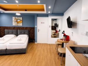 a bedroom with a bed and a table and a kitchen at Mini Studio N6 private Bathroom and Kitchenette in Limassol